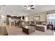 Open living room features a comfortable sectional sofa and views of the kitchen at 12410 Ballentrae Forest Dr, Riverview, FL 33579