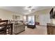 Spacious living room with large sectional sofa and access to the backyard at 12410 Ballentrae Forest Dr, Riverview, FL 33579