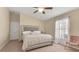Main bedroom with king bed, ceiling fan, and ample natural light at 12410 Ballentrae Forest Dr, Riverview, FL 33579