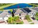 Two-story house with solar panels and a pond view in a residential area at 19510 Whispering Brook Dr, Tampa, FL 33647