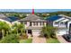 Two-story house with solar panels, brick driveway, and lush landscaping at 19510 Whispering Brook Dr, Tampa, FL 33647