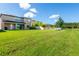 Expansive backyard with green lawn and distant water view at 19510 Whispering Brook Dr, Tampa, FL 33647