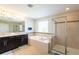 Bathroom with double vanity, soaking tub, and walk-in shower at 19510 Whispering Brook Dr, Tampa, FL 33647