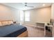 Bright bedroom with built-in workspace and ceiling fan at 19510 Whispering Brook Dr, Tampa, FL 33647