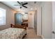 Bedroom with floral bedspread, ceiling fan, and ample closet space at 19510 Whispering Brook Dr, Tampa, FL 33647