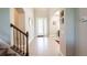Elegant entryway with tile flooring and a staircase with iron railing at 19510 Whispering Brook Dr, Tampa, FL 33647