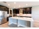 Modern kitchen with dark cabinetry, large island, and stainless steel appliances at 19510 Whispering Brook Dr, Tampa, FL 33647