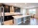Modern kitchen with dark cabinetry, quartz countertops, and stainless steel appliances at 19510 Whispering Brook Dr, Tampa, FL 33647