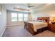 Main bedroom with large windows and ceiling fan at 19510 Whispering Brook Dr, Tampa, FL 33647