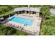 Community pool with lounge chairs and a poolside building at 19510 Whispering Brook Dr, Tampa, FL 33647