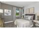 Bright bedroom with a queen-size bed and gray walls at 20249 Symphony Pl, Venice, FL 34293