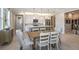 Bright dining area with a farmhouse table and chairs, adjacent to the kitchen at 20249 Symphony Pl, Venice, FL 34293
