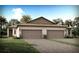 Two-story home with taupe siding, brown roof, and a two-car garage at 20249 Symphony Pl, Venice, FL 34293