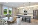 Spacious kitchen with white cabinets, gray island, and stainless steel appliances at 20249 Symphony Pl, Venice, FL 34293