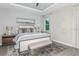 Large bedroom with a king-size bed, nightstands, and a stylish rug at 20249 Symphony Pl, Venice, FL 34293