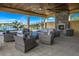 Relaxing covered patio with fireplace and wicker furniture at 20249 Symphony Pl, Venice, FL 34293
