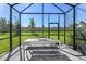 Relaxing screened patio with table and bench at 20249 Symphony Pl, Venice, FL 34293
