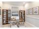 Home office with built-in shelving, desk, and stylish decor at 20249 Symphony Pl, Venice, FL 34293