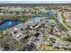Aerial view of community clubhouse, pool, and parking areas at 2029 Inverness Greens Dr # 2029, Sun City Center, FL 33573