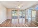 Living room with hardwood floors, sliding glass doors, and view of backyard at 2029 Inverness Greens Dr # 2029, Sun City Center, FL 33573