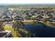 Community overview with lake and homes at 2029 Inverness Greens Dr # 2029, Sun City Center, FL 33573