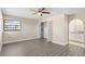 Bedroom with wood-look floors, a ceiling fan, and a large closet at 2139 Abby Ave, Spring Hill, FL 34609