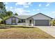 Updated ranch home with gray garage door at 2139 Abby Ave, Spring Hill, FL 34609