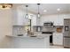 Modern kitchen with white cabinets, granite counters, and stainless steel appliances at 2139 Abby Ave, Spring Hill, FL 34609