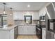 Modern kitchen with white cabinets, granite countertops, and stainless steel appliances at 2139 Abby Ave, Spring Hill, FL 34609