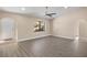 Spacious living room with light wood-look floors and a view to the front yard at 2139 Abby Ave, Spring Hill, FL 34609