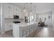 Open concept kitchen with island, stainless steel appliances, and white shaker cabinets at 2511 N Grady Ave # 26, Tampa, FL 33607