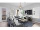 Spacious living room with gray sofas, a coffee table, and access to a balcony at 2511 N Grady Ave # 26, Tampa, FL 33607