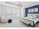 Large main bedroom with a blue accent wall, king-size bed, and plush carpet at 2511 N Grady Ave # 26, Tampa, FL 33607