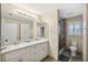 Bathroom with double vanity, granite countertop, and walk-in shower at 2601 Bay Blvd, Indian Rocks Beach, FL 33785