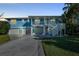 Two-story waterfront home with a two-car garage and a large deck at 2601 Bay Blvd, Indian Rocks Beach, FL 33785