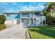 Two-story home with a two-car garage and a large deck at 2601 Bay Blvd, Indian Rocks Beach, FL 33785