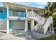 Two-story house with a two-car garage, front porch and stairs leading to second floor at 2601 Bay Blvd, Indian Rocks Beach, FL 33785