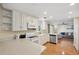 Bright kitchen boasts white cabinets, granite countertops, and overlooks the living area at 2601 Bay Blvd, Indian Rocks Beach, FL 33785