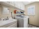 Laundry room with washer, dryer, and utility sink at 2601 Bay Blvd, Indian Rocks Beach, FL 33785