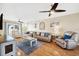 Spacious living room with hardwood floors, leather furniture, and ceiling fan at 2601 Bay Blvd, Indian Rocks Beach, FL 33785