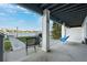 Relaxing patio area with waterfront views, grill, and swing at 2601 Bay Blvd, Indian Rocks Beach, FL 33785