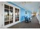 Spacious waterfront porch with rocking chairs and access to the water at 2601 Bay Blvd, Indian Rocks Beach, FL 33785
