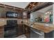 Updated kitchen featuring dark wood cabinets and granite countertops at 2987 Jodi Ln, Palm Harbor, FL 34684