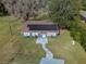 Aerial view of a blue house with solar panels at 34027 Saint Joe Rd, Dade City, FL 33525