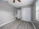 Bedroom with wood-look floors, ceiling fan, and spacious closet at 34027 Saint Joe Rd, Dade City, FL 33525