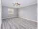 Well-lit bedroom with wood-look floors and a ceiling fan at 34027 Saint Joe Rd, Dade City, FL 33525