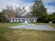 Blue house with solar panels and large grassy yard at 34027 Saint Joe Rd, Dade City, FL 33525