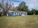 Blue house with solar panels and spacious yard at 34027 Saint Joe Rd, Dade City, FL 33525