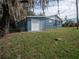 Side view of the house showing garage and AC unit at 34027 Saint Joe Rd, Dade City, FL 33525