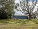 Blue house with deck and large oak trees at 34027 Saint Joe Rd, Dade City, FL 33525